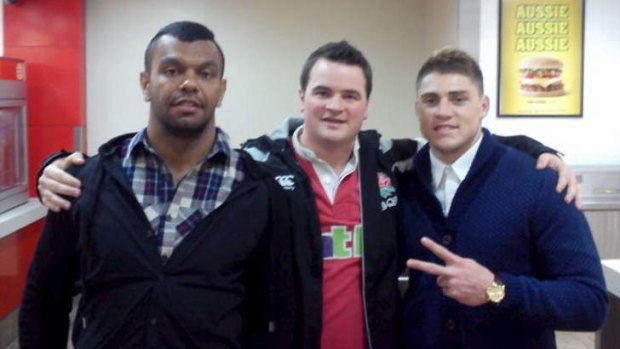 Hunger pains: Kurtley Beale and Hames O'Connor with a fan at Hungry Jack's in the early hours of Wednesday morning.