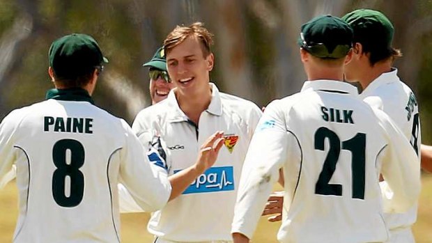 Prize scalp: Young Tasmanian seamer Sam Rainbird celebrates the wicket of NSW's Test skipper Michael Clarke for 88.