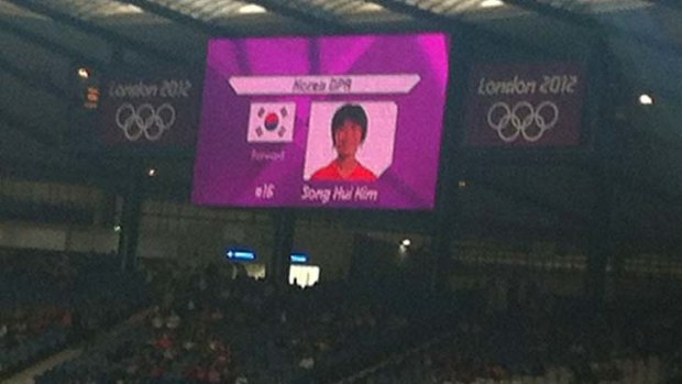 This mobile phone photo shows a  mistakenly displayed South Korean flag on a jumbo screen instead of North Korea's.