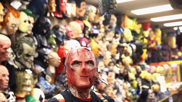 Robert Willis shops for a Halloween mask at a costume store.