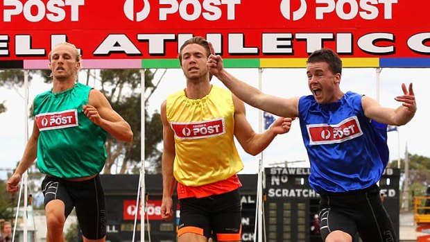 Andrew Robinson (far right) celebrates as he crosses the line to win the Stawell Gift.