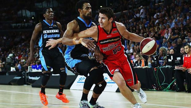 Damian Martin of the Wildcats gets around Mika Vukona of the Breakers.