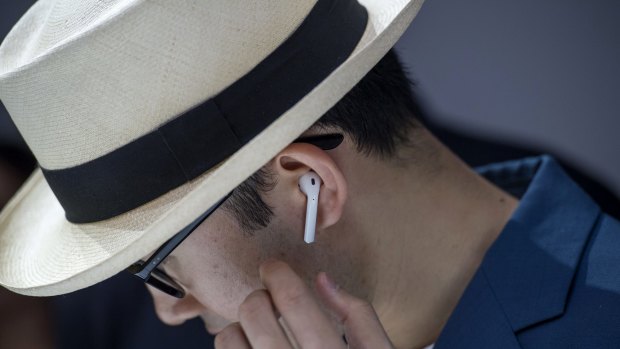 An attendee wears the Apple Inc. AirPod wireless headphones during an event in San Francisco, California, U.S., on Wednesday, Sept. 7, 2016. Apple Inc. unveiled new iPhone models Wednesday, featuring a water-resistant design, upgraded camera system and faster processor, betting that after six annual iterations it can still make improvements enticing enough to lure buyers to their next upgrade. Photographer: David Paul Morris/Bloomberg