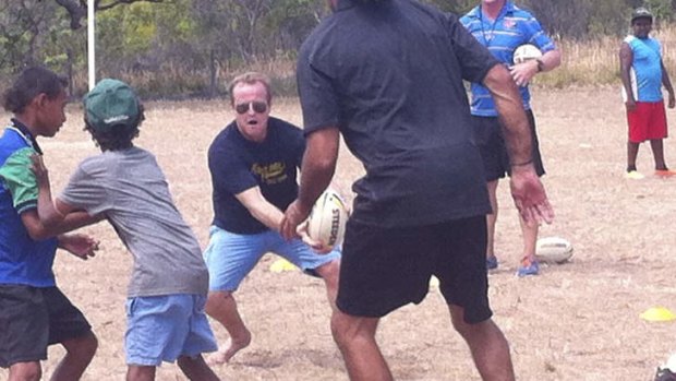 NRL head honcho Dave Smith showing off his on-field skills during a training drill with Cape York school kids.