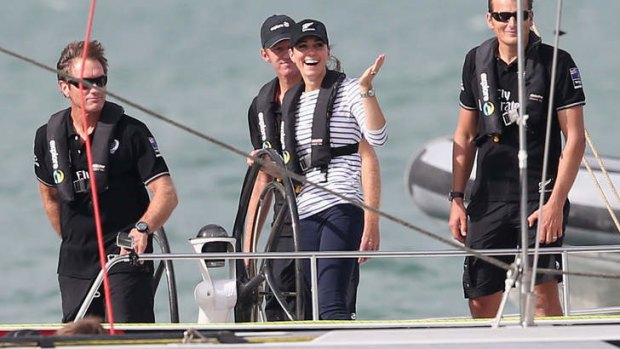 Catherine, Duchess of Cambridge gestures to Prince William, Duke of Cambridge, as she helms an America's Cup boat in a race against her husband in Auckland. The Duchess won.