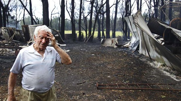 Morning after: Reg Hyde among the ruins of his building sheds in Salt Ash.
