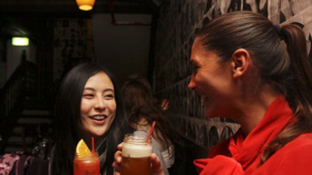 Raising jars to small bars ... Amanda Ibrahim, 28, and Megan Khoury, 31, enjoy a drink after work at the Grasshopper Bar on Temperance Lane in the Sydney CBD.