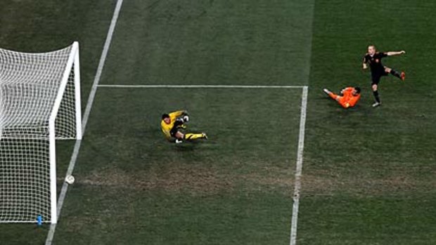 The moment ... Spain's midfielder Andrés Iniesta scores the winning goal past Netherlands' goalkeeper Maarten Stekelenburg during extra time.