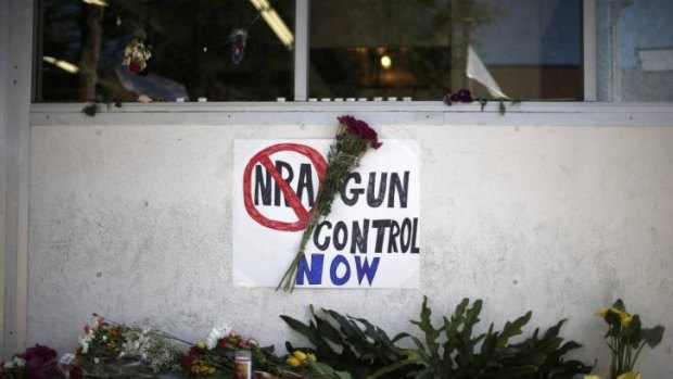 A sign advocating gun control is seen on a makeshift memorial for 20-year-old university student Christopher Michael-Martinez.