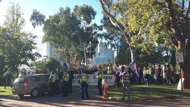 Protesting manufacturing workers block the entrance to Parliament House.