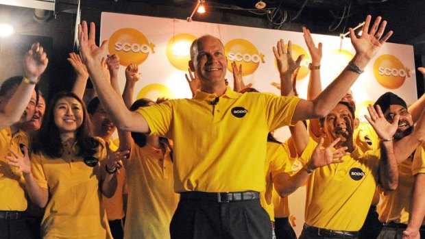 Scoot's chief executive Campbell Wilson (C) celebrates at the unveiling of the new low-cost carrier.