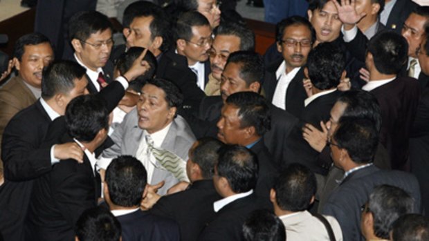 Uproar ... Indonesian politicians jostle each other yesterday after debate about the bank bailout was stopped.
