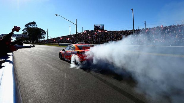 Letting off smoke ... Whincup celebrates his win. Next year Holden and Ford will have competition.