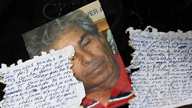 A picture of Mario Gomez, one of 33 miners trapped in a deep underground copper and gold mine, with the letter he sent his wife.