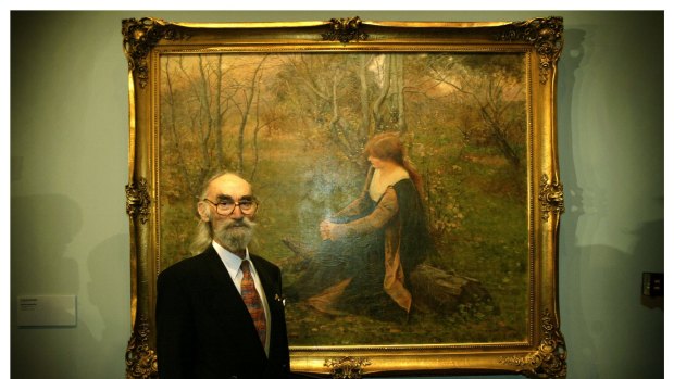 Joseph Brown stands in front of  <i>Autumn Memories</i>  by Frederick McCubbin.