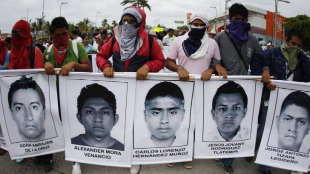 Student activists carry portraits of the missing Mexican students during a march in Acapulco on Friday.