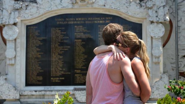 Victims of terror comfort each other in front of the Bali Memorial in Kuta, Bali.