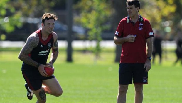 Melbourne coach Paul Roos watches Mitch Clark during training.