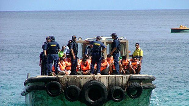 The sixth boat-load of asylum seekers to arrive in two months is taken to Christmas Island.