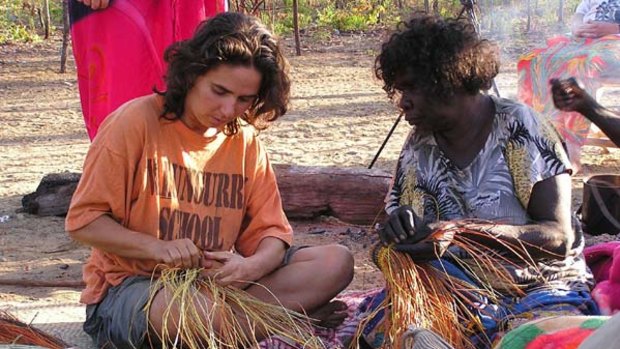 Stitch in time ... an expert weaver at Mapuru teaches a traveller the art of basket weaving.