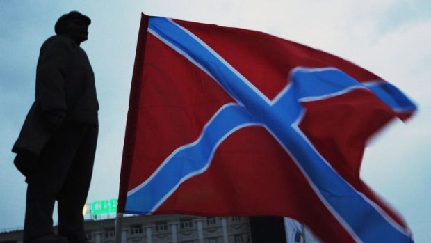 The 'New Russia' flag flying next to a Lenin statue in Donetsk,