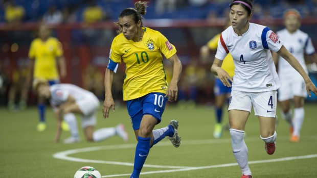 World's best: Brazil's Marta, left, is chased by South Korea's Shim Seoyeon at the Women's World Cup in Montreal.    