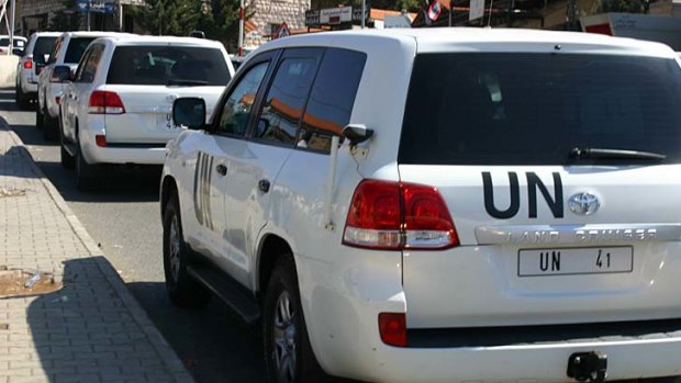 A convoy of United Nations vehicles is seen as a chemical weapons disarmament team cross into Syria.