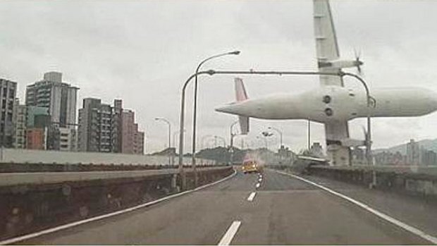 A TransAsia plane clips an overpass and a taxi before crashing. 