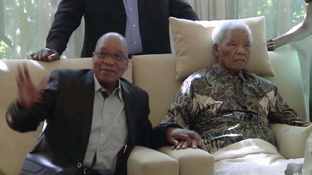 Jacob Zuma sits with Nelson Madela in televised images.