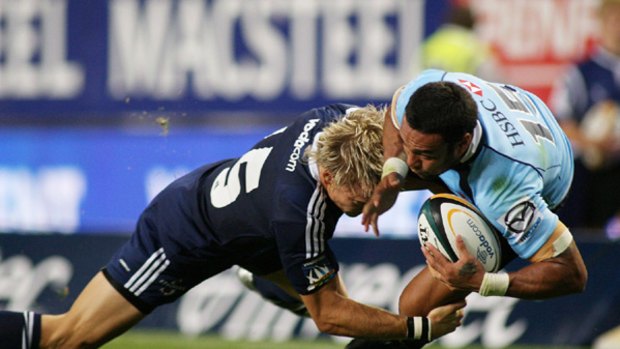 Sosene Anesi of Australia's Waratahs, right, is tackled by Joe Pietersen of South Africa's Stormers, left, during the Super 14 rugby match in Cape Town on Saturday, February 20, 2010.