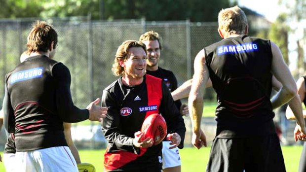 Essendon great James Hird trains at Windy Hill yesterday with a few old teammates.