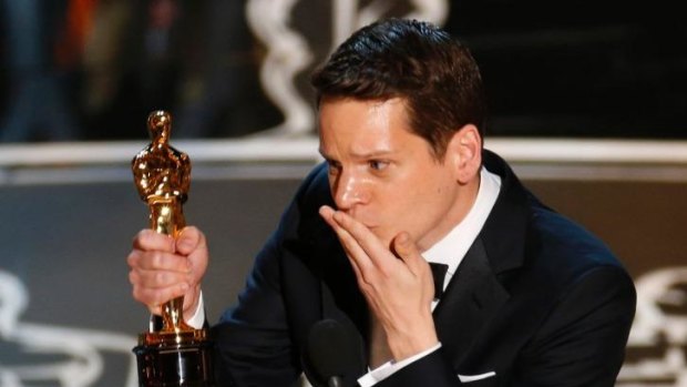 Writer Graham Moore accepts the Oscar for best adapted screenplay for the film 'The Imitation Game' and dedicates his win to 'that kid out there who feels like she's weird, or she's different, or she doesn't fit in anywhere.'