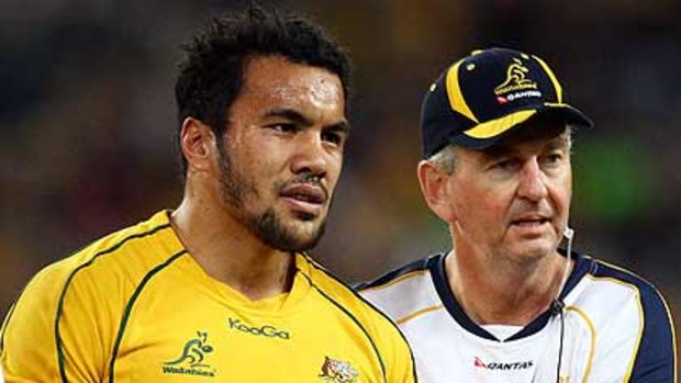 Wallabies winger Digby Ioane is led from the field with a dislocated shoulder.