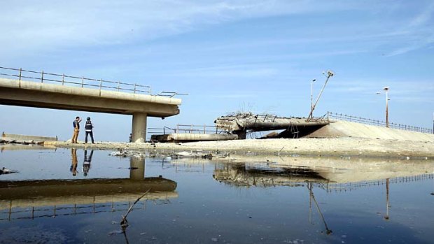 A destroyed bridge is seen after what witnesses said was a hit by an Israeli air strike in central Gaza Strip