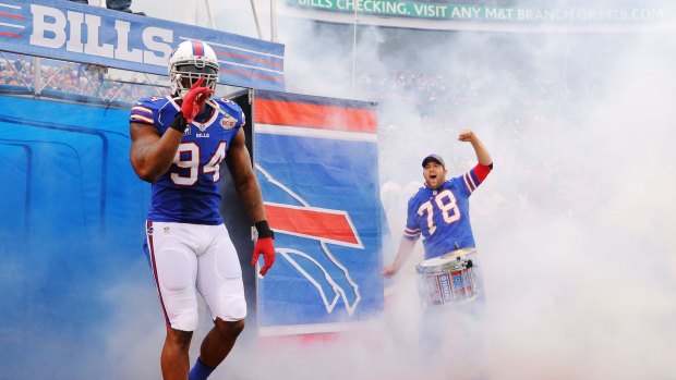 Mean machine: Mario Williams leads Buffalo Bills onto the field at Ralph Wilson Stadium.