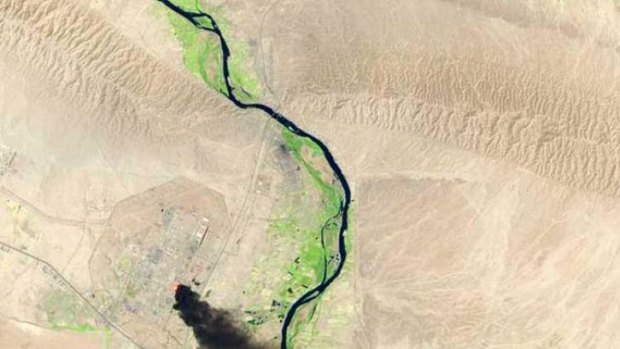 A satellite view of the battle from Baiji last month shows smoke billowing from Iraq's largest oil refinery complex.