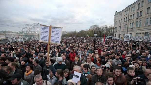 Opposition protesters listen to a speech during a major protest rally in Bolotnaya Square in Moscow, Russia, Monday, May 6, 2013.