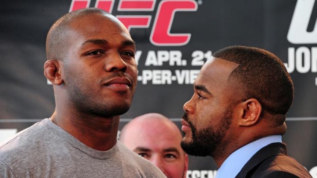 Defending UFC light heavyweight champion Jon Jones (left) gives the cold shoulder to his opponent, Rashad Evans, during a press conference to promote Sunday's title showdown.