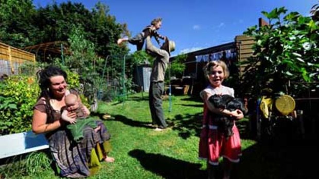 Mel Alexander, Andy Higgins and their children Bronte, Banjo and Merri enjoy their backyard.