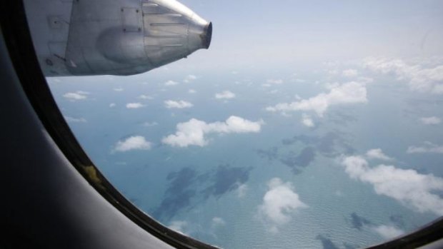 Clouds hover outside the window of a Vietnam Air Force search and rescue aircraft.