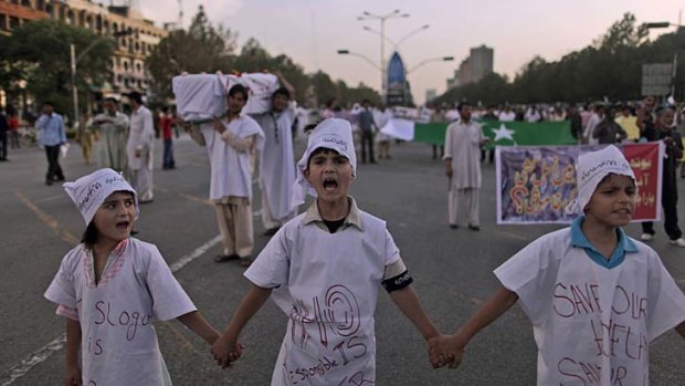 Anger... children chant slogans in a protest again al-Qaeda and the US in Islamabad.