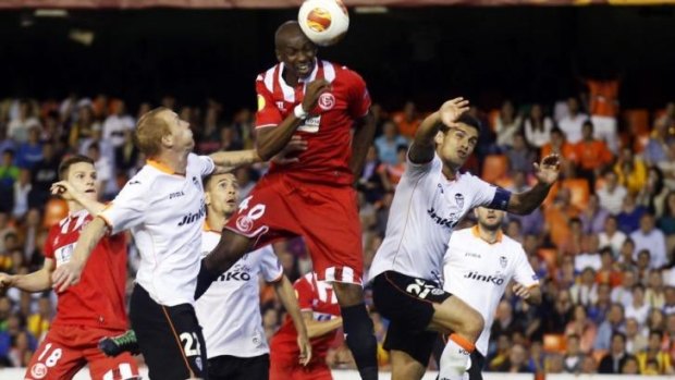 The winner: Stephane Mbia (C) heads the ball to score the decisive goal. 