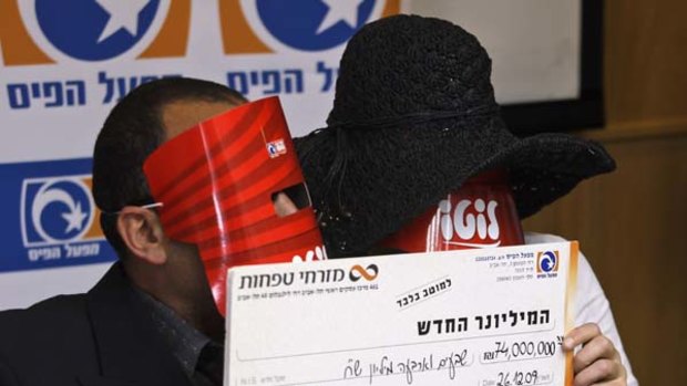 Winners ... the Israeli couple wore masks to protect their identities.