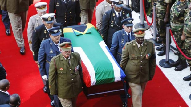 Dignified ... pallbearers carry the coffin at the state funeral of Albertina Sisulu yesterday.