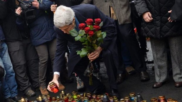 Respect: US Secretary of State John Kerry at a memorial for anti-government protesters killed in Kiev.