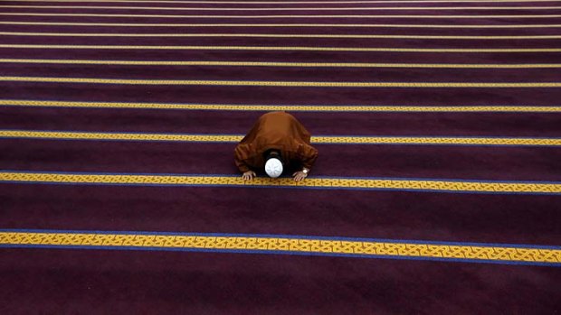 Purified: A man prays during Eid al-Fitr at Lakemba mosque on Thursday. Eid al-Fitr marks the end of the Muslim holy fasting month of Ramadan.