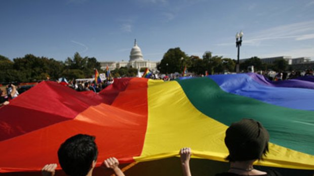Demonstrators carry a rainbow flag while marching in Washington DC at the weekend.