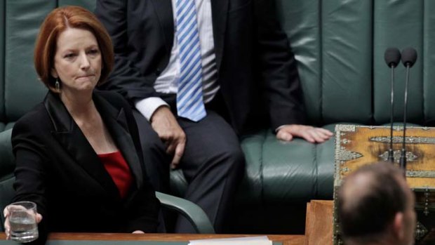 Committed &#8230; Julia Gillard listens to Tony Abbott in Parliament yesterday.