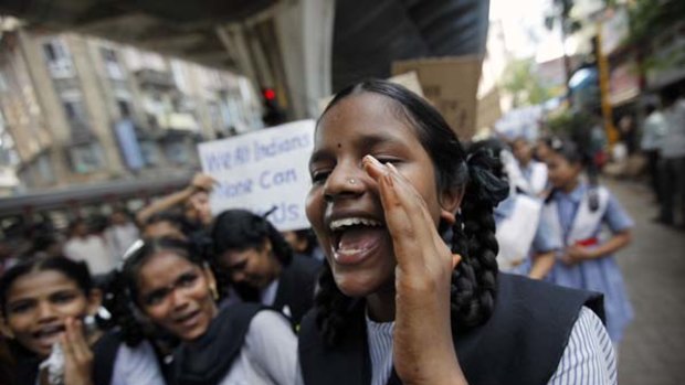"Peace, harmony and tranquillity"... a schoolgirl shouts slogans during a rally organised to appeal for calm in Mumbai.