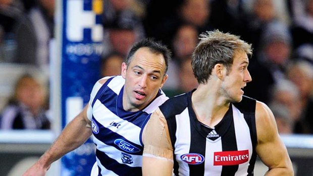 Ben Reid is chased by Geelong's James Podsiadly.